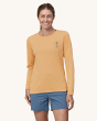 An adult wearing the Patagonia Women's Long-Sleeved Capilene Cool Daily Graphic Shirt - Clean Climb Bloom / Sandy Melon X-Dye, with a Patagonia flower inside a carabiner logo on the front of the top.