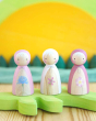 Peepul eco-friendly wooden wildflower peg dolls lined up on a yellow and green background