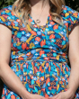 Close up of the blue, red and yellow tropical print on the Piccalilly organic cotton womens wrap dress