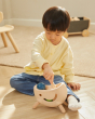 Young child pushing the balls on the PlanToys miracle pounding toy with the wooden mallet