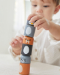 Close up of young boy making a tower with the PlanToys arctic animals matching figures on a white table