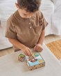 Close up of young boy making a picture of a dog with the PlanToys solid wooden animal puzzle cubes