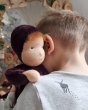 A child cuddling the Moss Violet Senger doll 