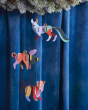 Studio Roof DIY card animal hanging decorations hanging from a Christmas tree in front of a blue curtain