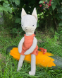 Tobe soft plush hemp fox toy sat on a large orange and green vegetable