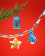 Tony's blue and orange chocolate bars hanging from a Christmas tree and a paper chain of chocolate wrappers on a red background