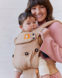 Close up of woman carrying a baby in the Tula explore mesa linen baby carrier