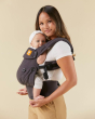 Close up of woman holding a baby in the Tula explore hemp baby carrier in the obsidian colour