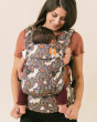 Close up of woman carrying a baby on her front in the Tula soft structured explore baby carrier
