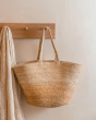 Turtle Bags natural block colour jute basket hanging on a wooden coat hanger 