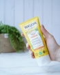Weleda Energy Aroma Shower Gel 200ml a yellow tubes of natural ginger shower gel in an adults hand