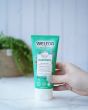 Weleda Harmony Aroma Shower Gel 200ml, a green tube of natural shower gel in an adults hand