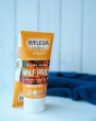 Weleda Vitality Aroma Creamy Body Wash 200ml - OFFER, two orange tubes of natural sea buckthorn creamy body wash with  Buy 1 Get 1 Half Price band, with a blue towel in the bckground