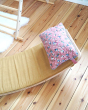 Close up of the Wobbel eco-friendly deck and pillow cushion accessories on a Wobbel XL balance board on a wooden floor