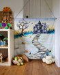 Wondercloths Halloween themed organic cotton play cloth hung up by the side of shelving full of various wooden toys 