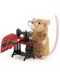 A closer view of the details on the The Makerss Needle Felt Sewing Mouse. A beautifully crafted beige coloured fluffy mouse with a pink tail, glasses and a tiny sewing machine and fabric, stood on a white background