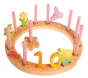 Grimm's 16-Hole Natural Wooden Celebration Ring decorated with pink candles and decorative figures for a tenth birthday
