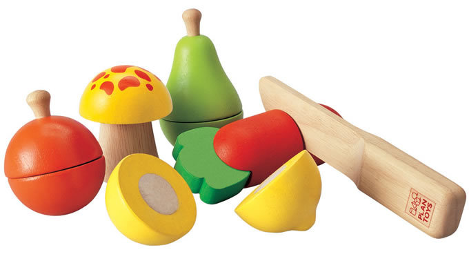 The PlanToys wooden fruit and veggie set for the play kitchen includes a pear, lemon, orange, mushroom, carrot, and wooden toy knife. White background.