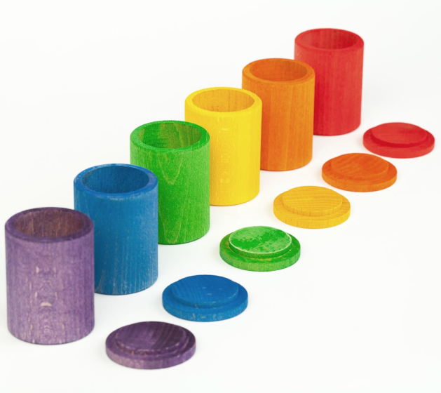 Grapat 6 Wooden Toy Rainbow Cups with lids off, lined up in rainbow colour order. For colour matching, sorting, stacking and holding treasures. White background. 