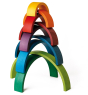 9 piece Naef wooden rainbow stacked on top of each other to form a colourful tower on a white background. 