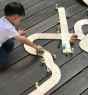 Child playing with the Plan Toys Standard Road System