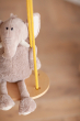 Close up of toy elephant sitting on a Babai eco-friendly wooden swing set above a wooden floor
