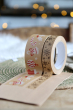 Close up of the Babipur eco kraft paper tapes in the snowflake and Christmas decorations prints, taped to some card in front of some Christmas lights
