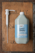 Bio-D screw on pump for 5 litre bottles, next to a 5ltr cleansing handwash bottle on a wooden background
