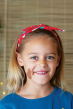 Girl wearing let's party Astrid headband with Christmas theme