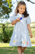 Child taking part in an egg and spoon race wearing the  Frugi Beach Hut Blue and white Stripe Cassie Collared Dress