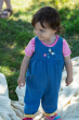 Child wearing the Frugi Chambray Bumblebee yellow Daisies Gracie Reversible Dungaree on the chambray denim side 