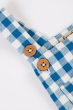 Close up of the button closures on the straps of teh A child wearing the Frugi  Deep Sea Check/Crab Alby Dungaree with a yellow short sleeved t-short underneath 