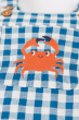 close up of the embroidered crab on teh front of the Frugi  Deep Sea Check/Crab Alby Dungaree
