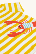 A closer look at the lobster applique on the yellow and white stripe t-shirt of the Frugi Organic Easy On Outfit - Dandelion Stripe / Lobster, on a cream background