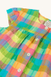A closer look at the capped sleeves, buttons and Summertime Check print on the Frugi Organic Elisa Top - Summertime Check, on a cream background