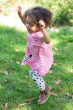 child wearing the Frugi pink breton stripe dog Little Layla Dress