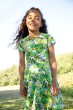 Child smiling wearing the Frugi Hedgerow print Spring Skater Dress