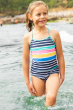 Child standing in water wearing the Frugi Indigo Stripe Kiri Tankini 