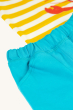 A closer look at the light blue shorts and pockets of the Frugi Organic Easy On Outfit - Dandelion Stripe / Lobster. The yellow and white stripe t-shirt is in the background, under the shorts