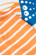 A closer look at the orange and white stripe pattern of the pyjama shorts, and the jellyfish print on the pyjama top of the Frugi Children's Organic Cotton Porthleven Pyjamas - Jellyfish.