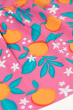 A closer look at the loose top gathering and orange blossom print showing the beautiful detail of the oranges, blossom flowers and leaves, on the Frugi Organic Tessa Top - Orange Blossom