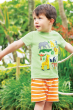 A child playing outside wearing the Frugi Organic Little Creature Applique T-Shirt - Kiwi Marl / Jungle, and Frugi Tangerine Breton Shorts