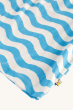 A closer view of the wave pattern on the Frugi Daisies Melody top, on a cream background