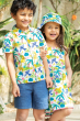 Two children stood together and smiling, the child on the right is wearing the Frugi Organic Seraphina Dress - Jaguar Jungle