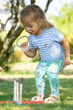 Child wearing the Frugi Tide Stripe Rabbits Ennis Embroidered T-Shirt with duck pond print libby leggings 