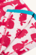 A closer view of the inside on the Frugi Children's Organic Cotton Havana Hooded Towel - Raspberry Whales. A hot pink hooded towel with white while horizontal whale print. The inside of the towel is white with hot pink whale print, with blue piping. On a 