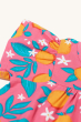 A clover look at the ruffled sleeves and orange blossom print showing the beautiful detail of the oranges, blossom flowers and leaves on the Frugi Organic Tessa Top - Orange Blossom. On a cream background