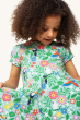 A child looking down at the Frugi Children's Organic Cotton Spring Skater Dress - Tropical Birds. A beautiful tropical bird and flower print on a twirly short sleeve skater dress they are wearing