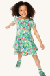 A child happily posing and wearing the Frugi Children's Organic Cotton Spring Skater Dress - Tropical Birds. A beautiful tropical bird and flower print on a twirly short sleeve skater dress, on a cream background