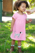Child wearing the Frugi pink breton stripe dog Little Layla Dress